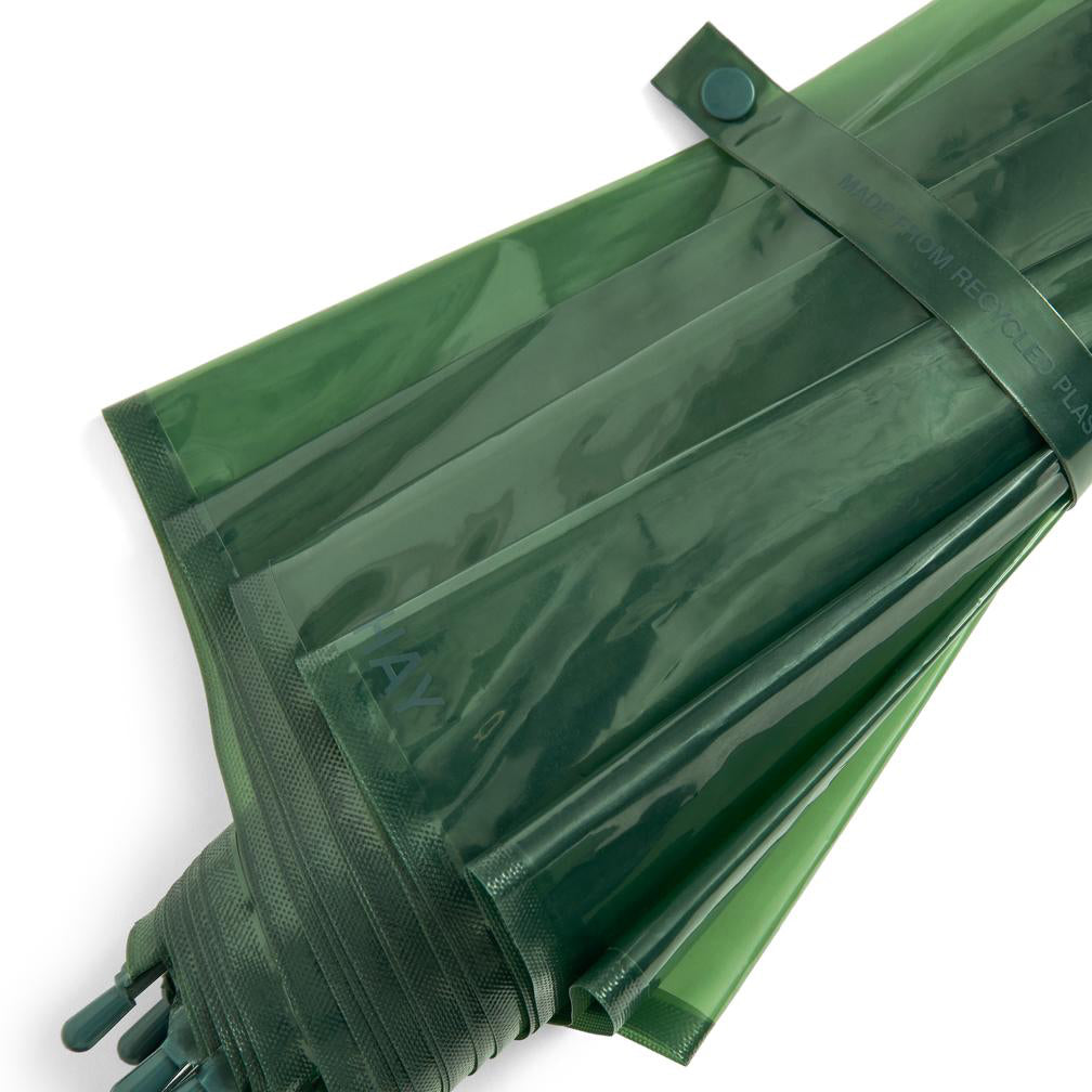 A dark green translucent waterproof umbrella sleeve or cover, folded and secured with a matching strap and snap button, shown on a plain white background.