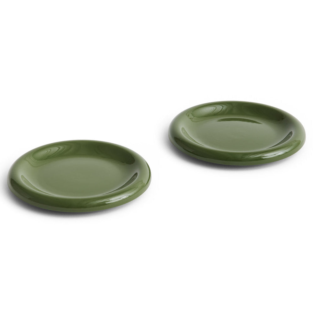 Two green ceramic plates on a white background