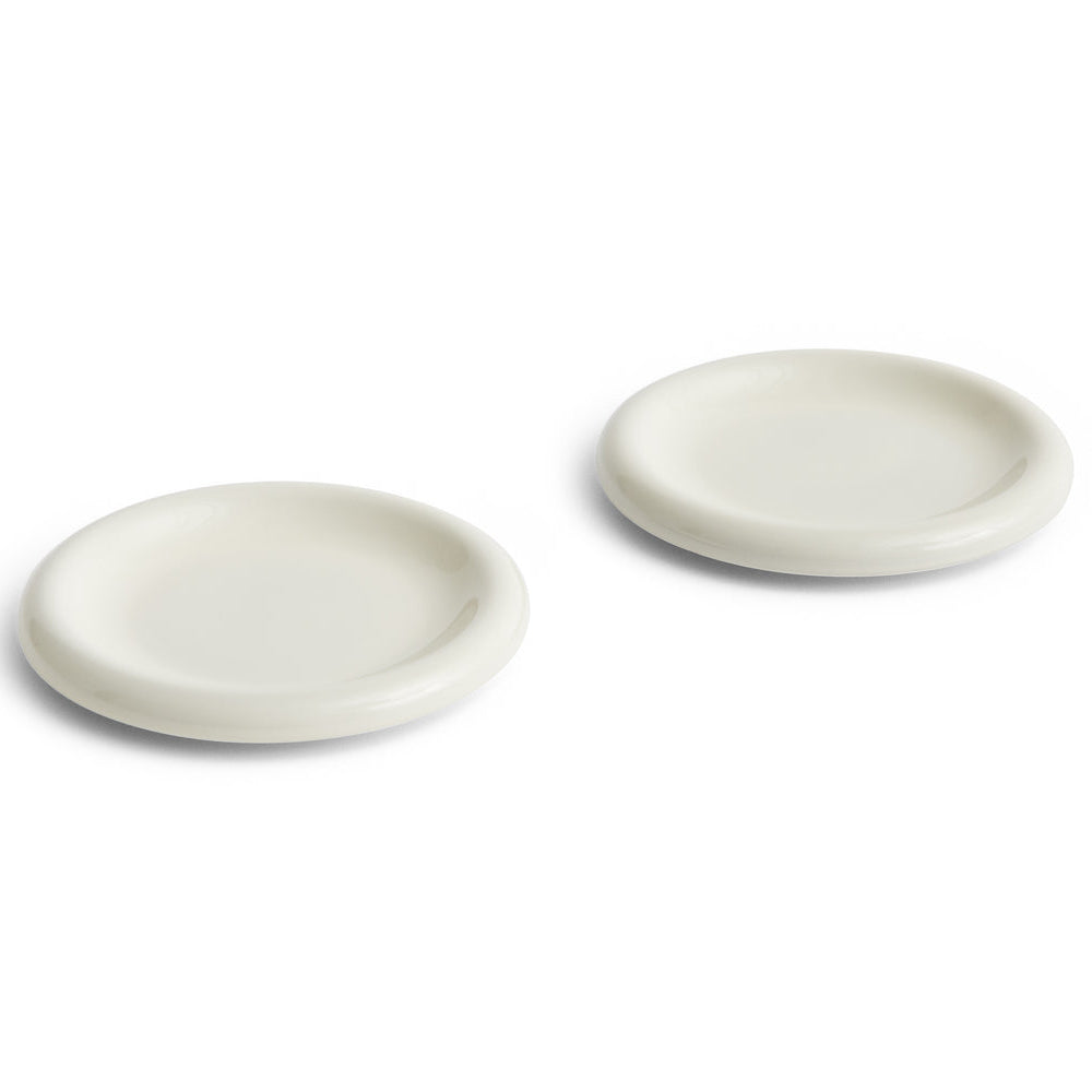 Two white ceramic plates on a white background