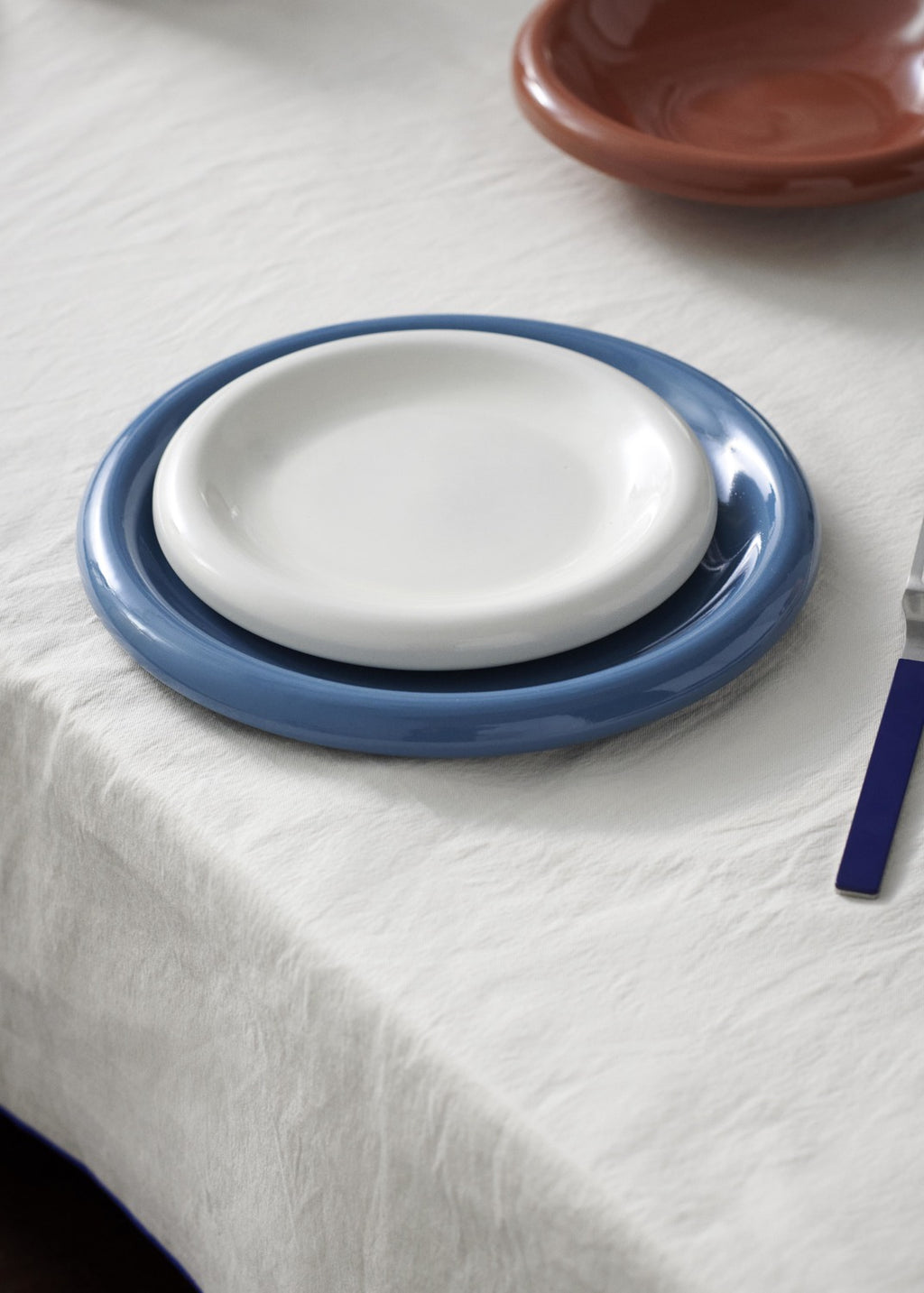Set of ceramic plates on a white tablecloth