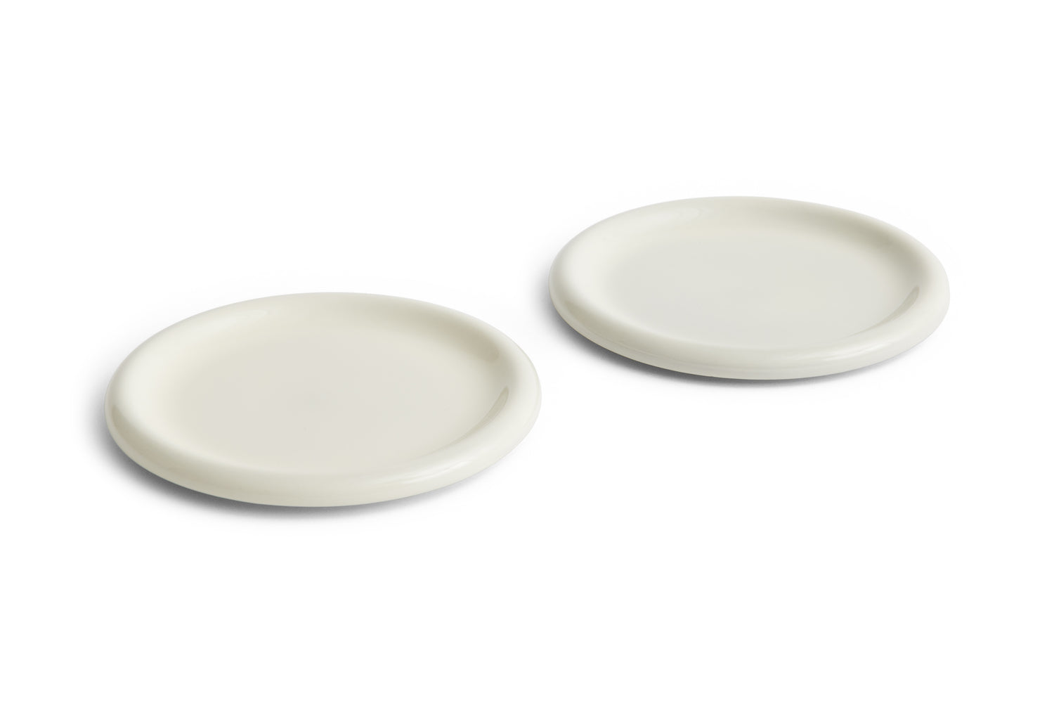 Two white ceramic plates on a white background