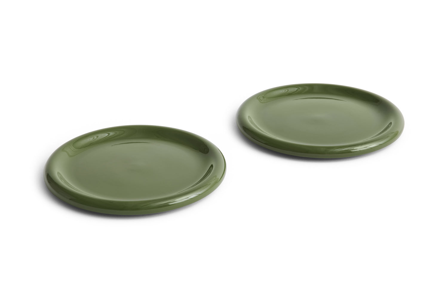 Two green ceramic plates on a white background
