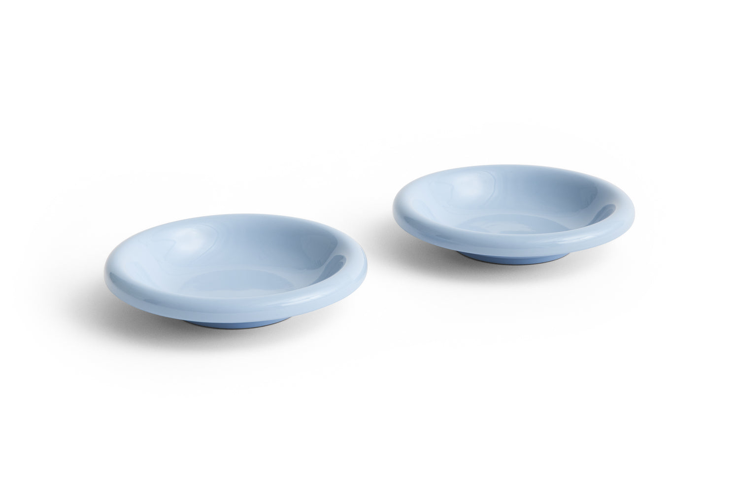Two small light blue ceramic bowls on a white background