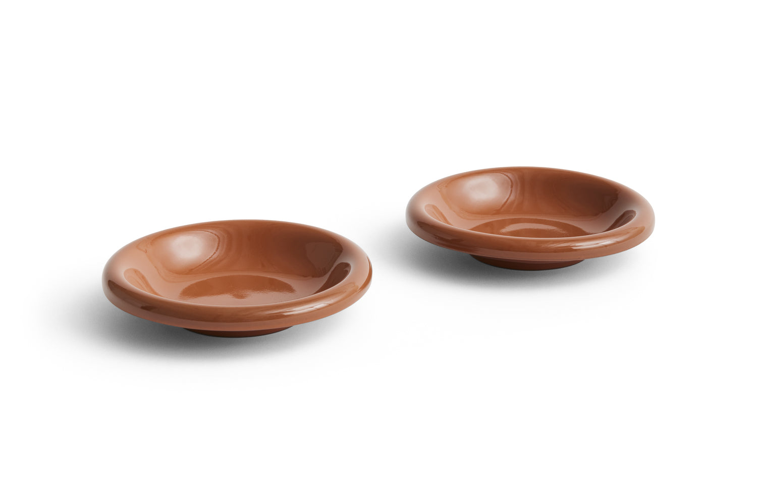 Two brown ceramic bowls on a white background