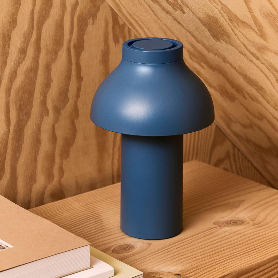 Blue lamp on a wooden surface with books