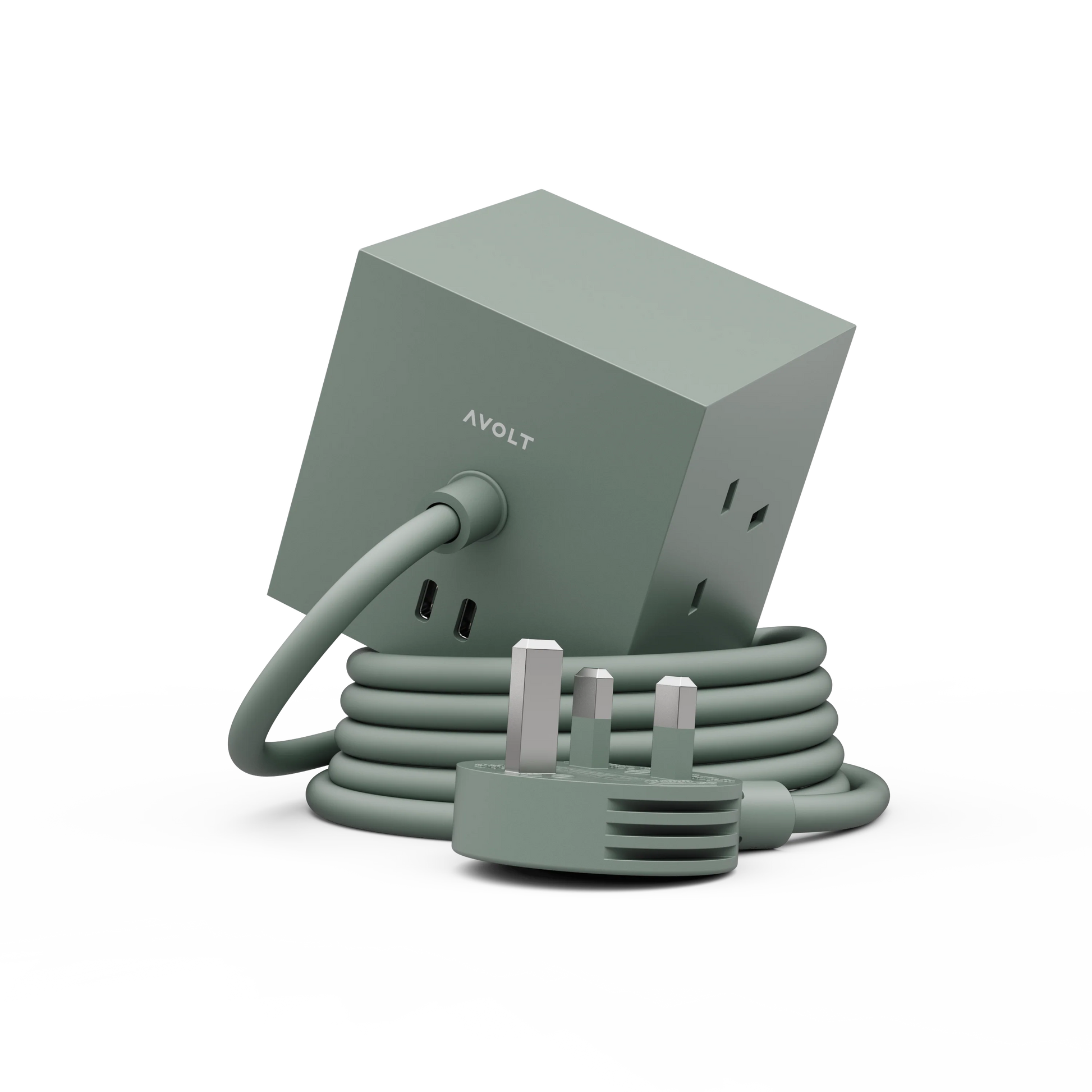 A sage green AVOLT power adapter with a cube-shaped housing, coiled cord, and UK three-pin plug, shown on a clean white background.
