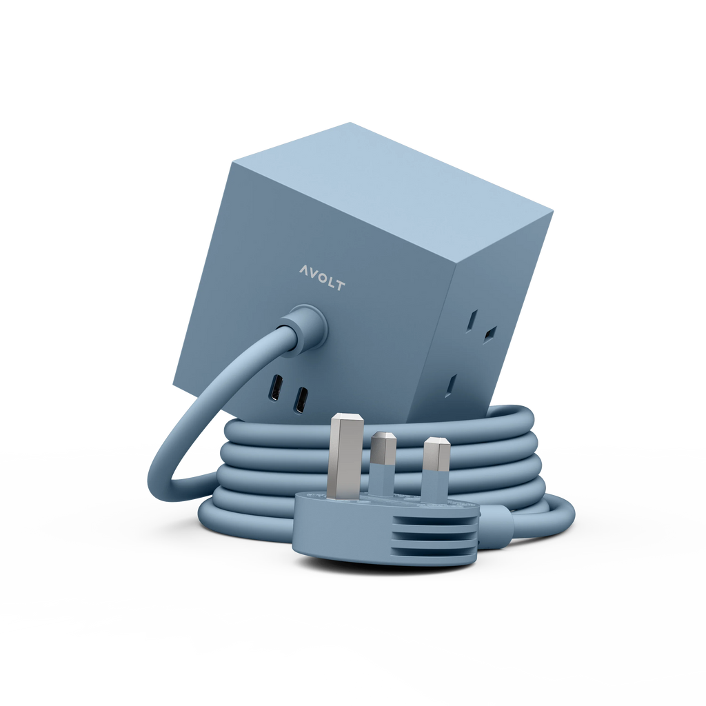 A light blue cube-shaped AVOLT power adapter with a matching coiled power cord and UK three-pin plug, shown on a clean white background.