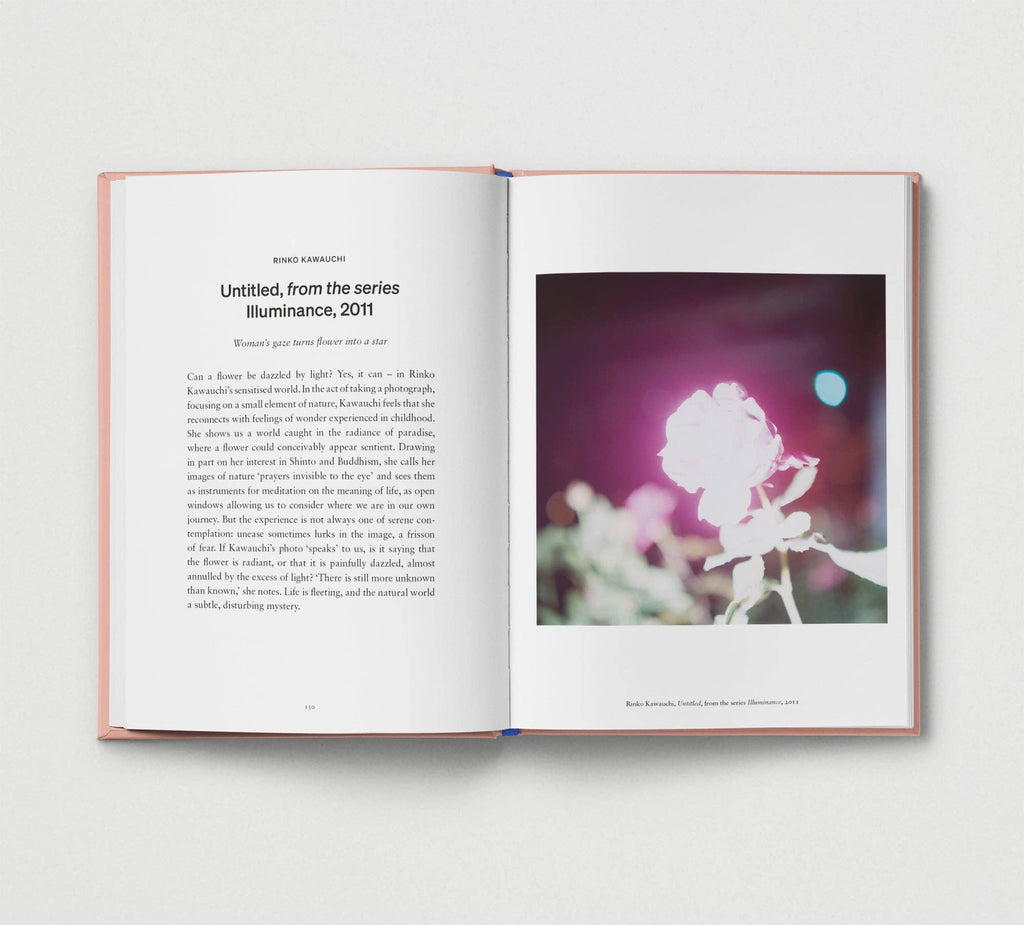 Open book with text and a photograph of a flower on a white background