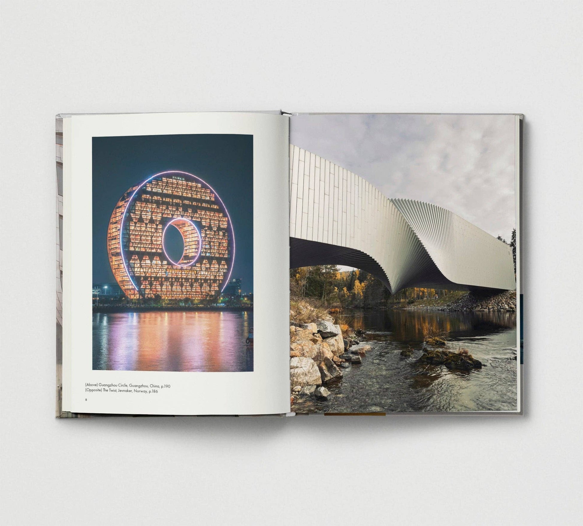 Open book showing two architectural photographs on a white background