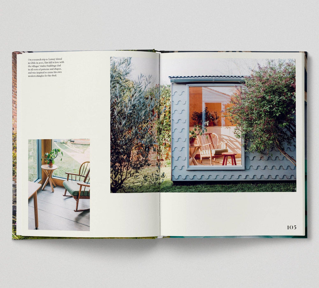 Open book showing a photograph of a small house with a garden on a white background