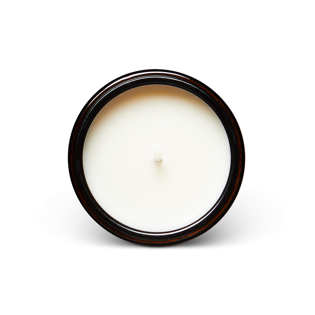 White candle in a black container on a white background