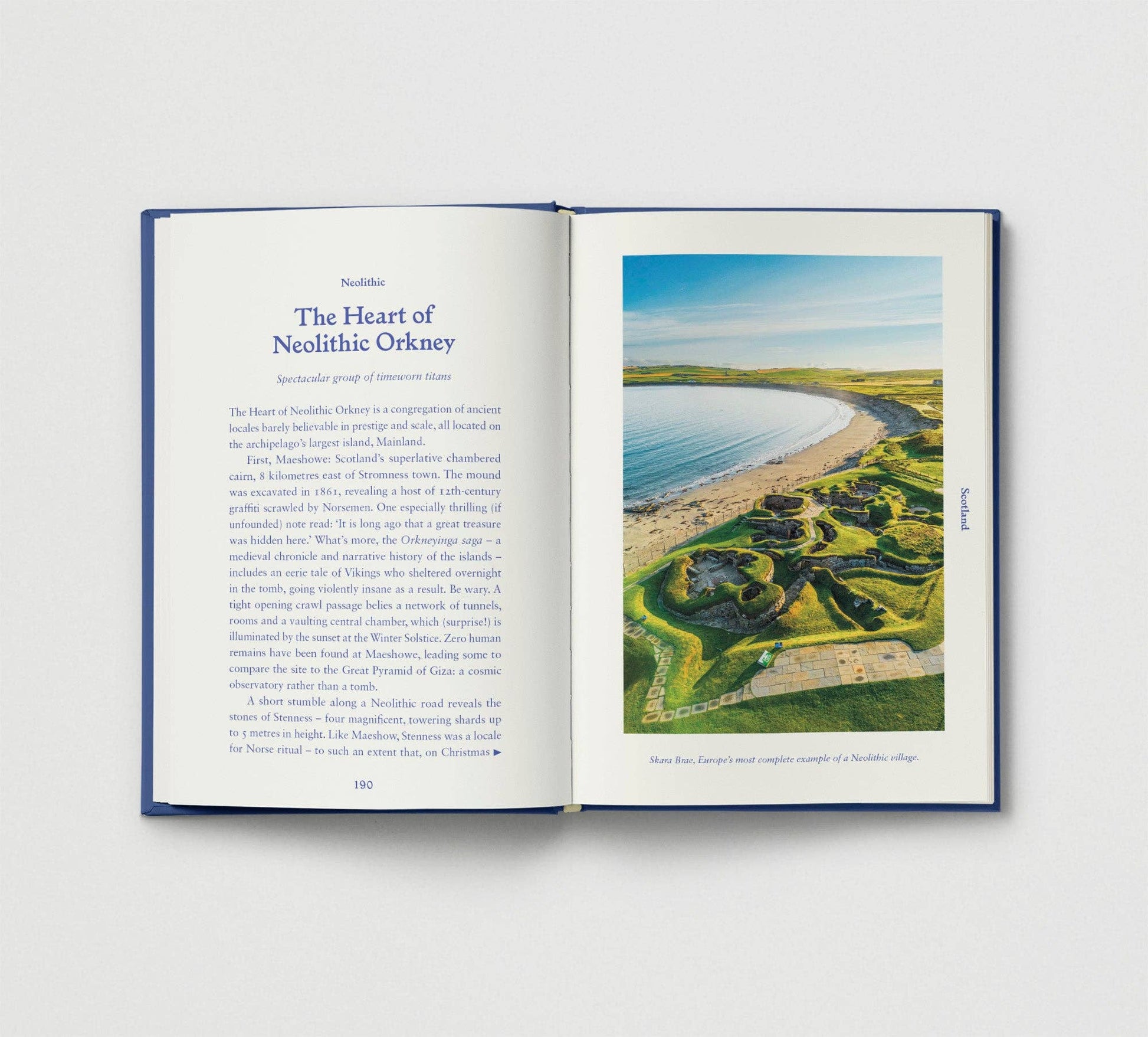 Open book showing a page with text and an image of a coastal landscape.