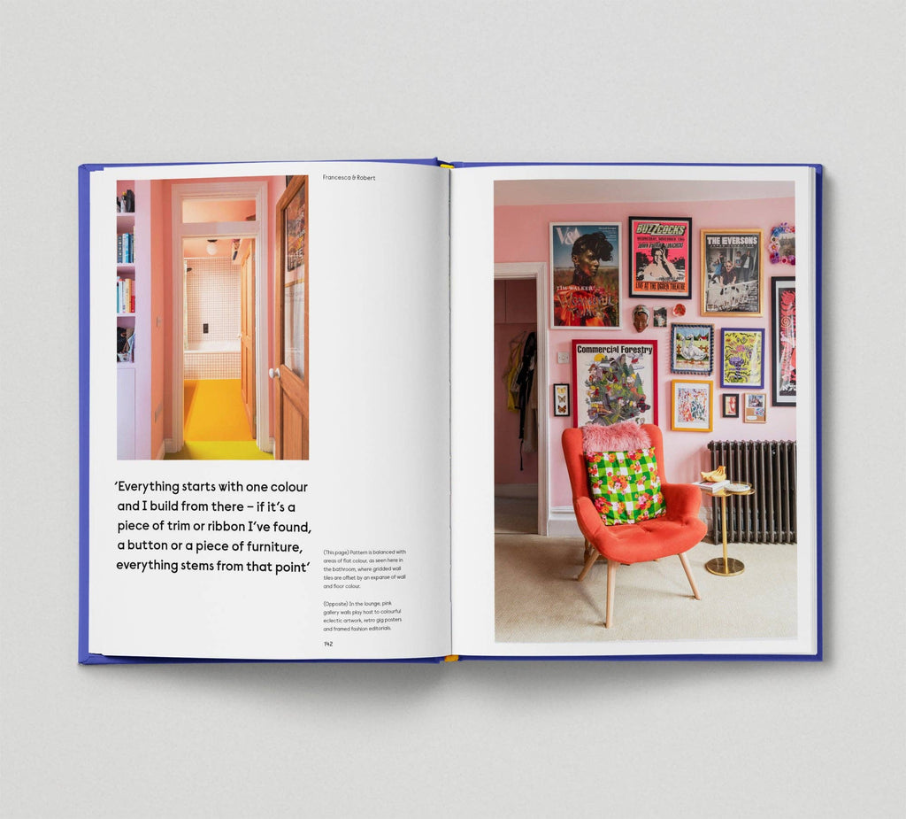 Open book showing interior design pages with colorful room and chair.