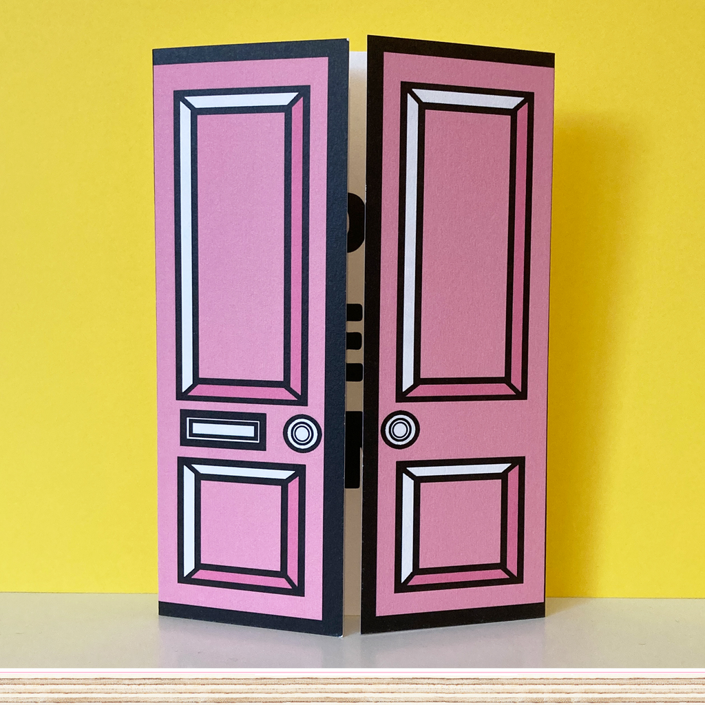 Pink greetings card with pink door on yellow background