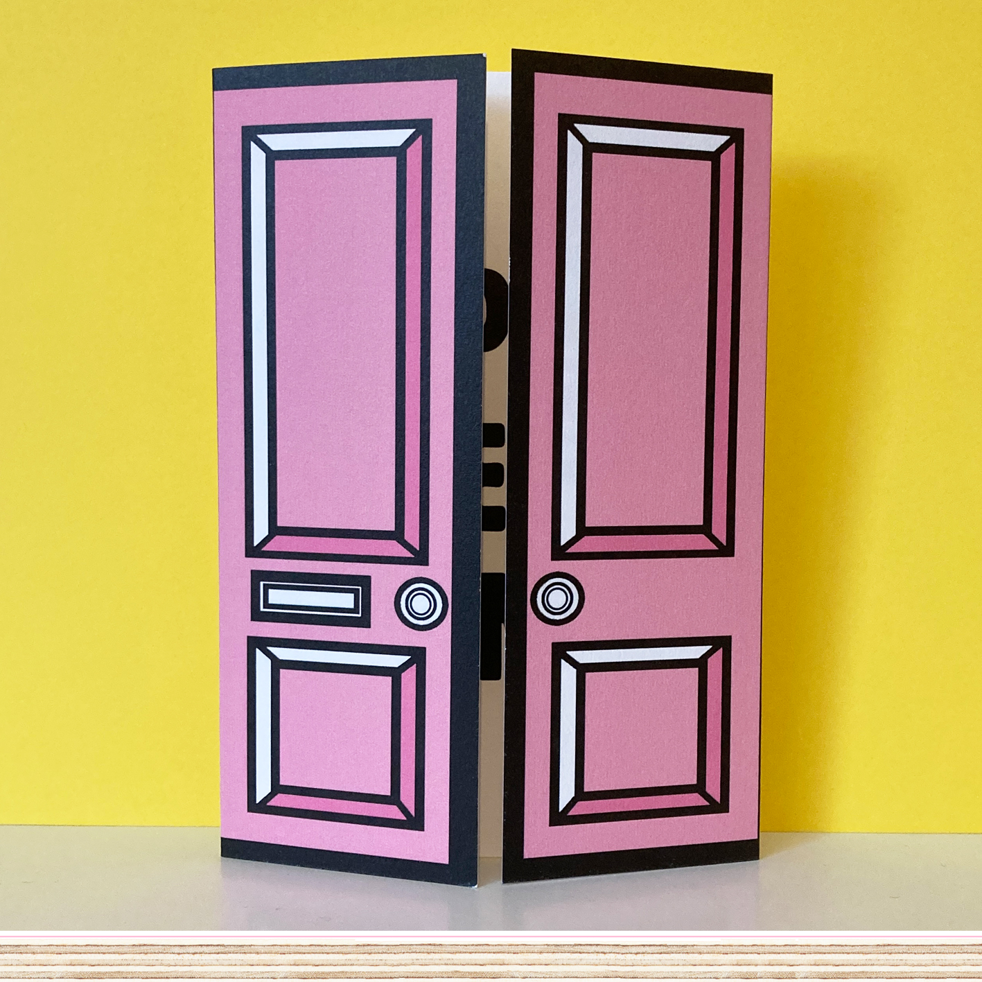 Pink greetings card with pink door on yellow background