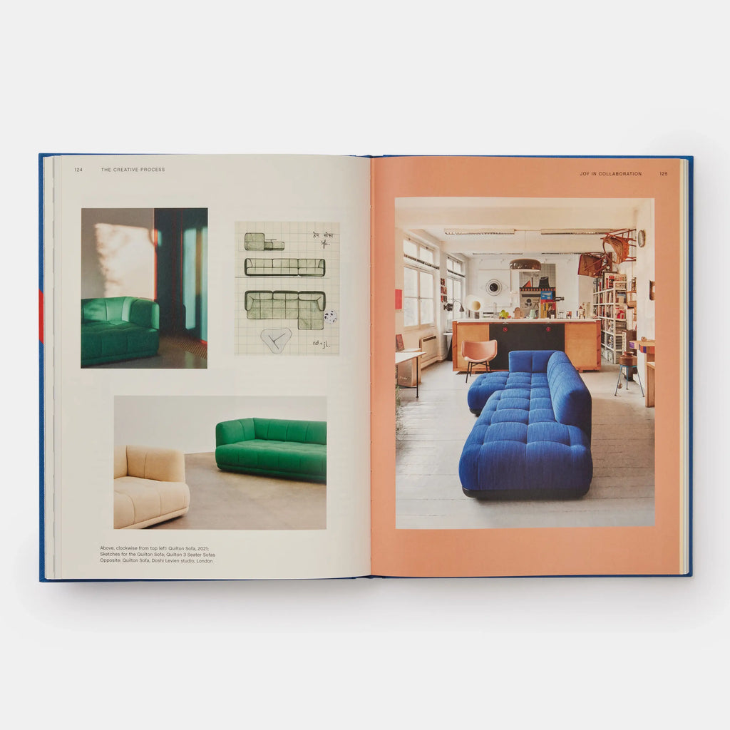 Open book showing images of colorful sofas in a room setting