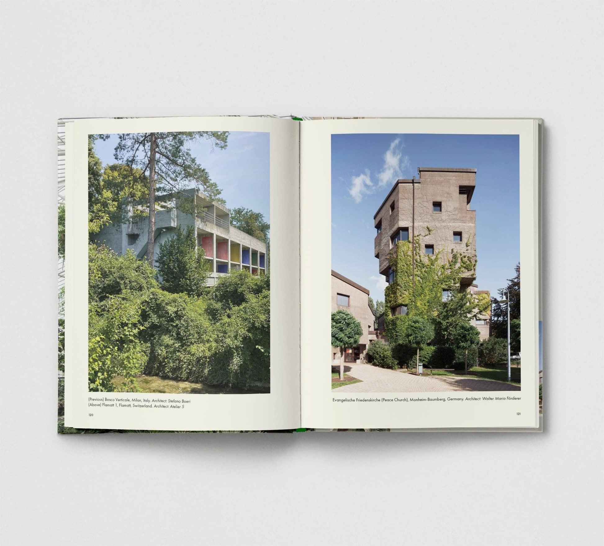 Open book showing two architectural photographs on a white background