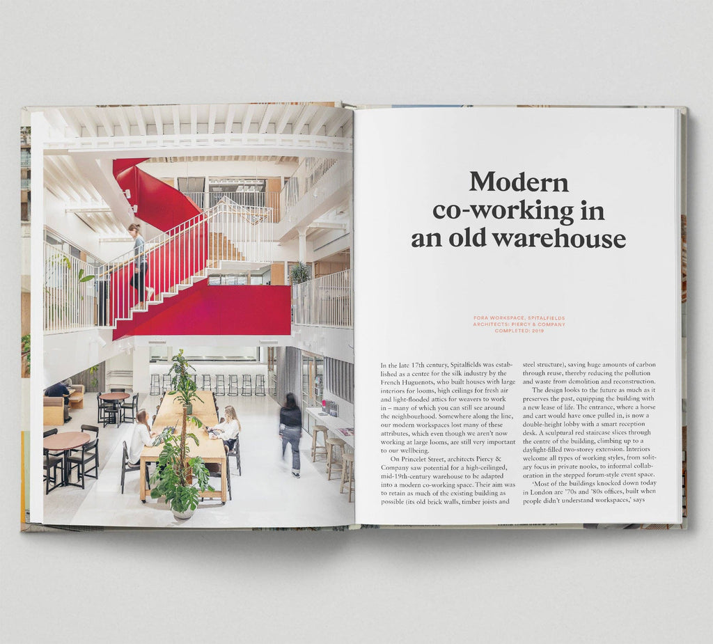 Open book showing a modern co-working space in an old warehouse with a red staircase.