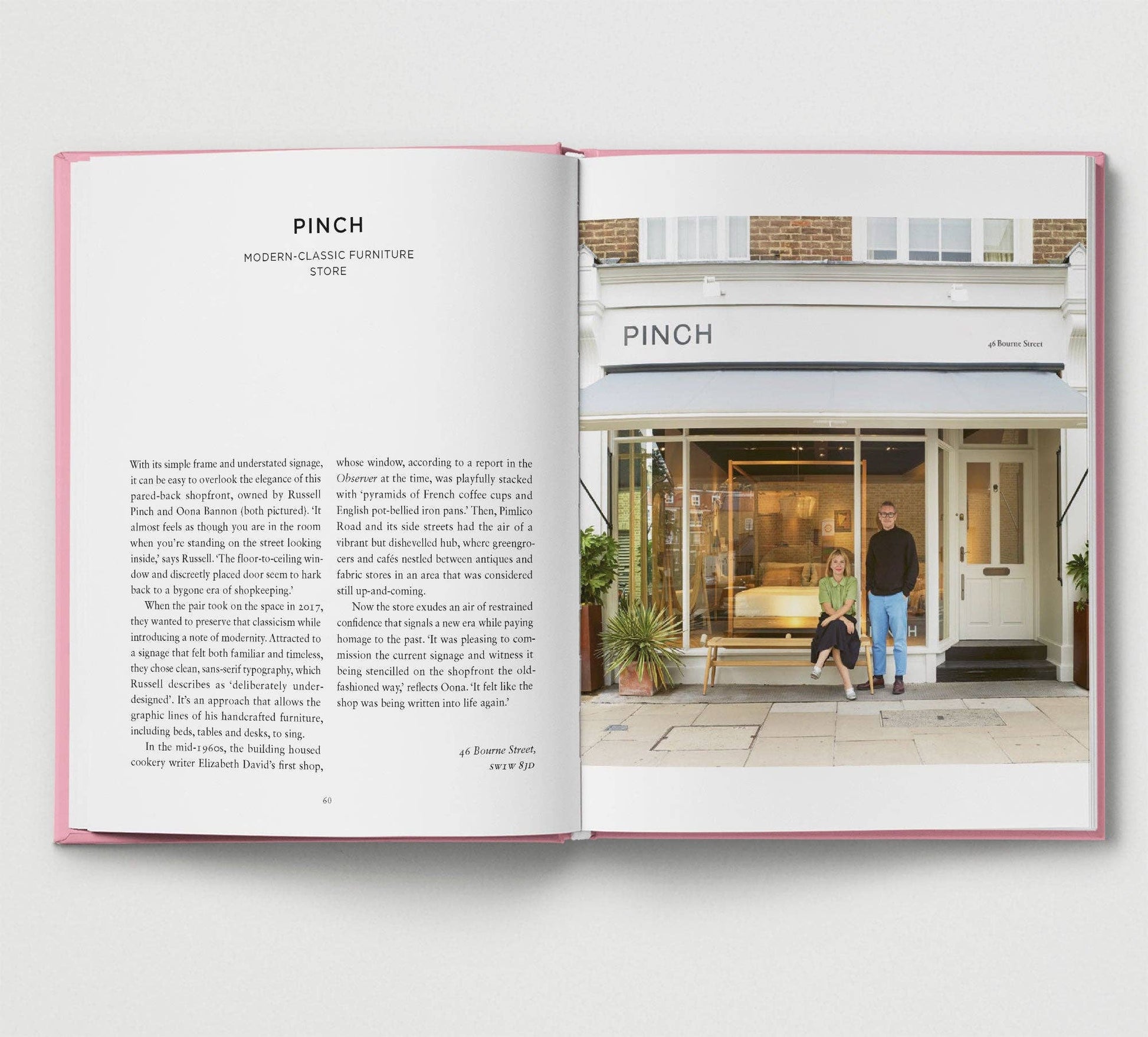 Open book showing a photograph of a store front with people outside, titled 'PINCH'.