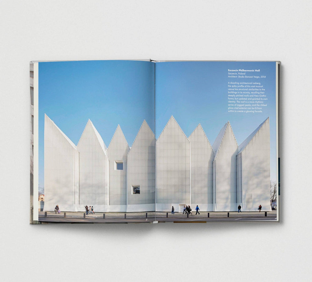 Open book showing a photograph of a modern architectural structure with a blue sky.