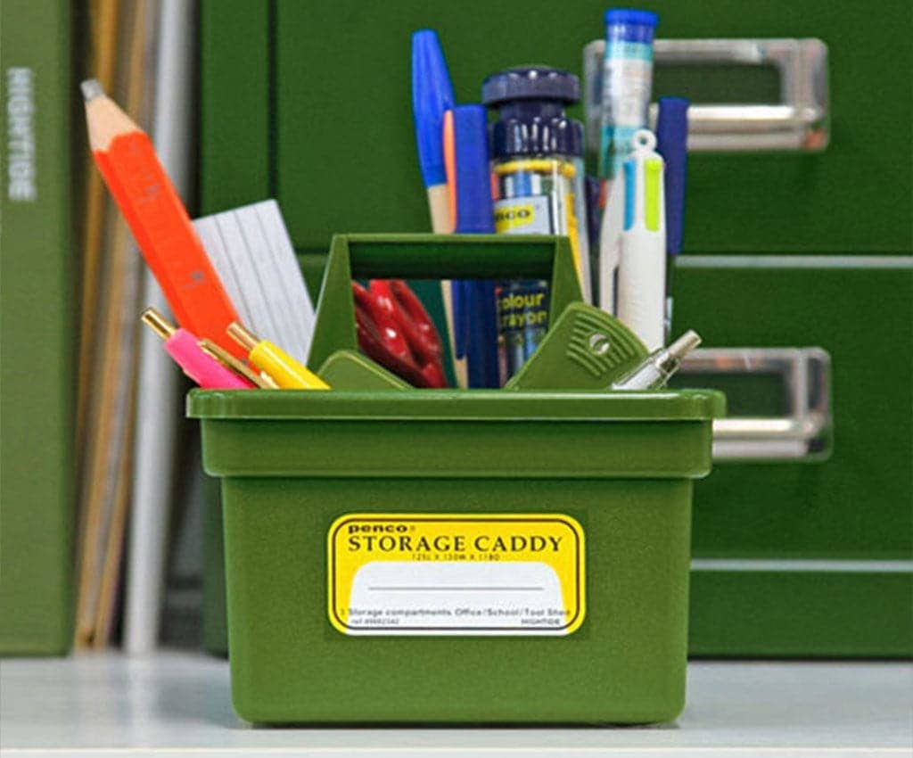 Green storage caddy filled with office supplies against a green background