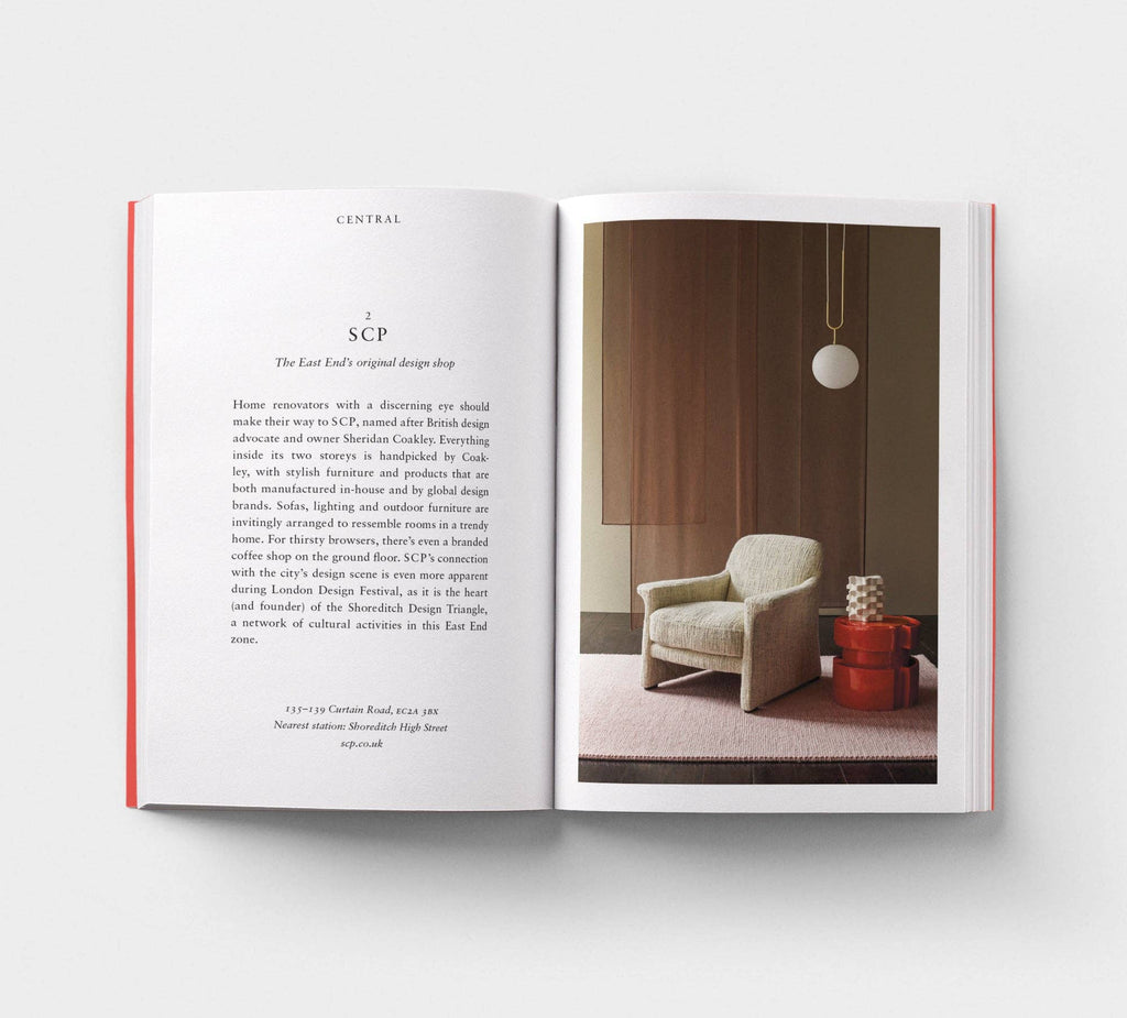 Open book showing interior design layout with text and a photo of a room with a chair and lamp.