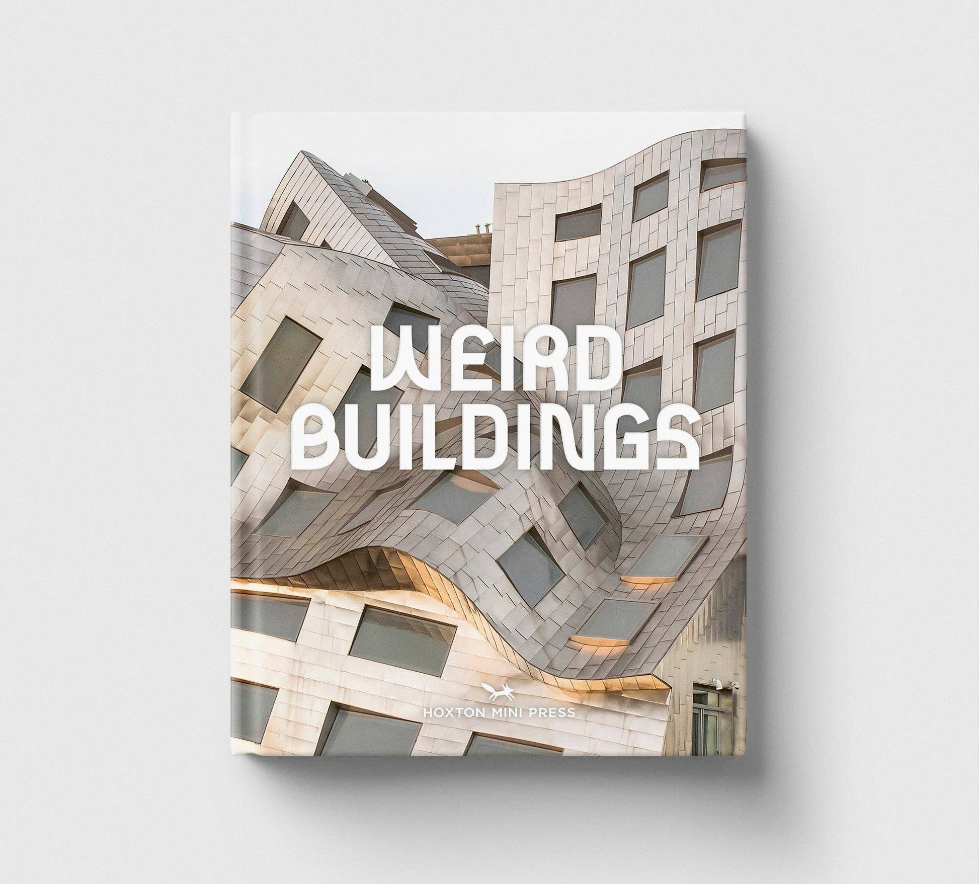 Book titled 'Weird Buildings' with architectural design on the cover against a light gray background