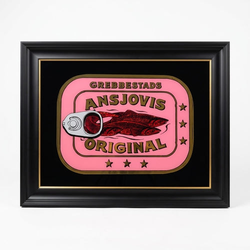A framed novelty wall art piece featuring a parody design of a canned food label. The design has a pink background with the text 'GREBBESTADS ANSJOVIS ORIGINAL' and an illustration of two fish, with a pull-tab can opener graphic on the left.